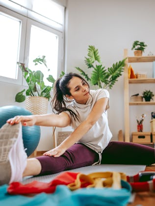 A woman works out at home.