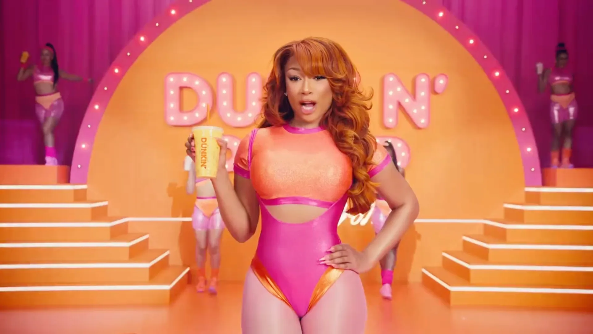 Megan Thee Stallion's wore an '80s-era bodysuit with cutouts for a Dunkin' ad.