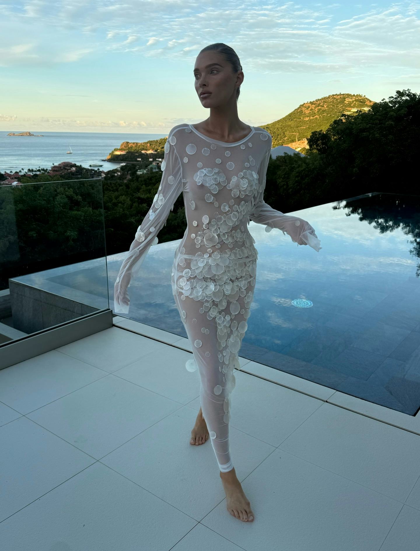 Elsa Hosk wears a sheer white dress. 