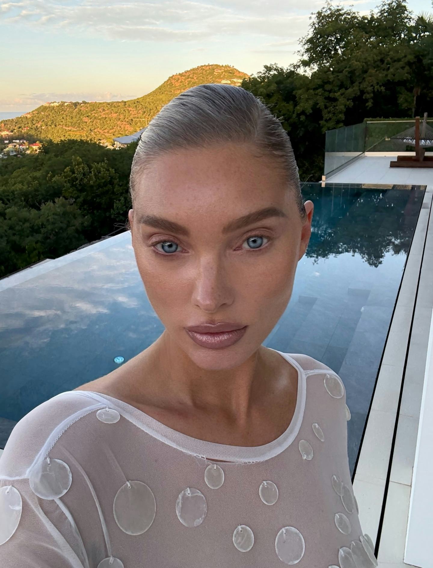 Elsa Hosk wears a sheer white dress. 