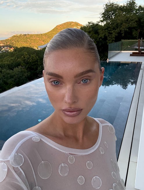 Elsa Hosk wears a sheer white dress.