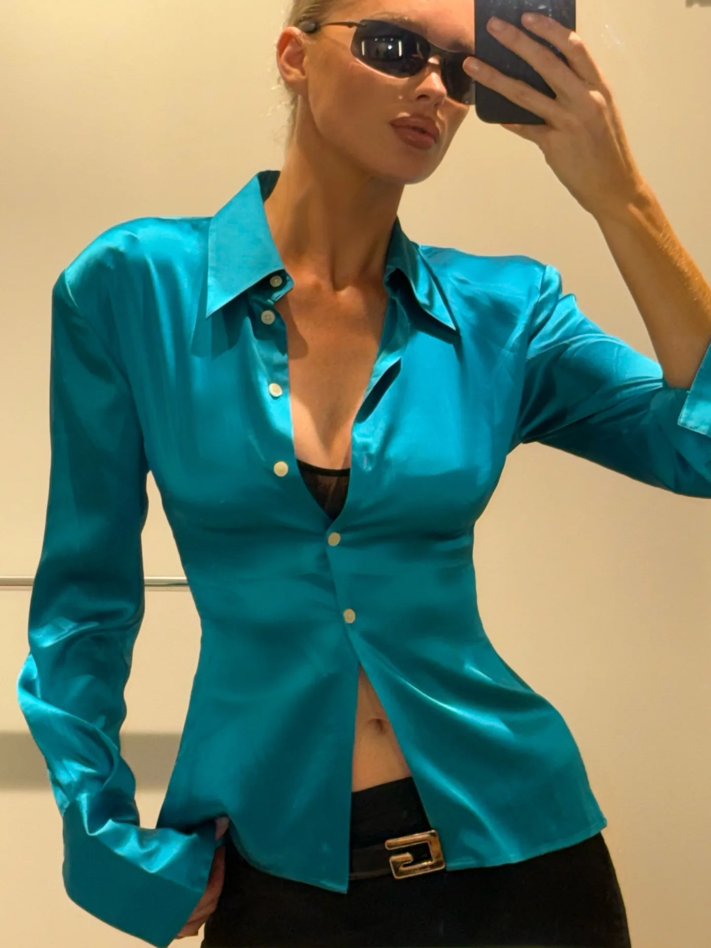 Elsa Hosk wears an ocean blue button down and skirt. 