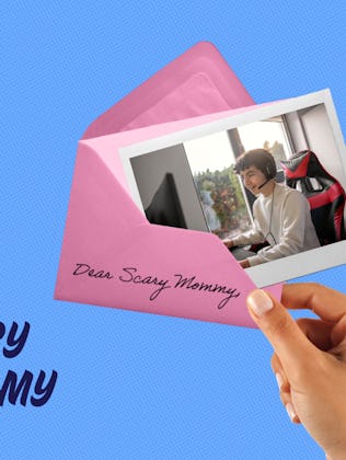 A picture of a teenaged boy playing on a computer, pushed halfway into an envelope.