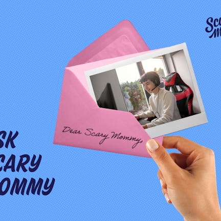 A picture of a teenaged boy playing on a computer, pushed halfway into an envelope.