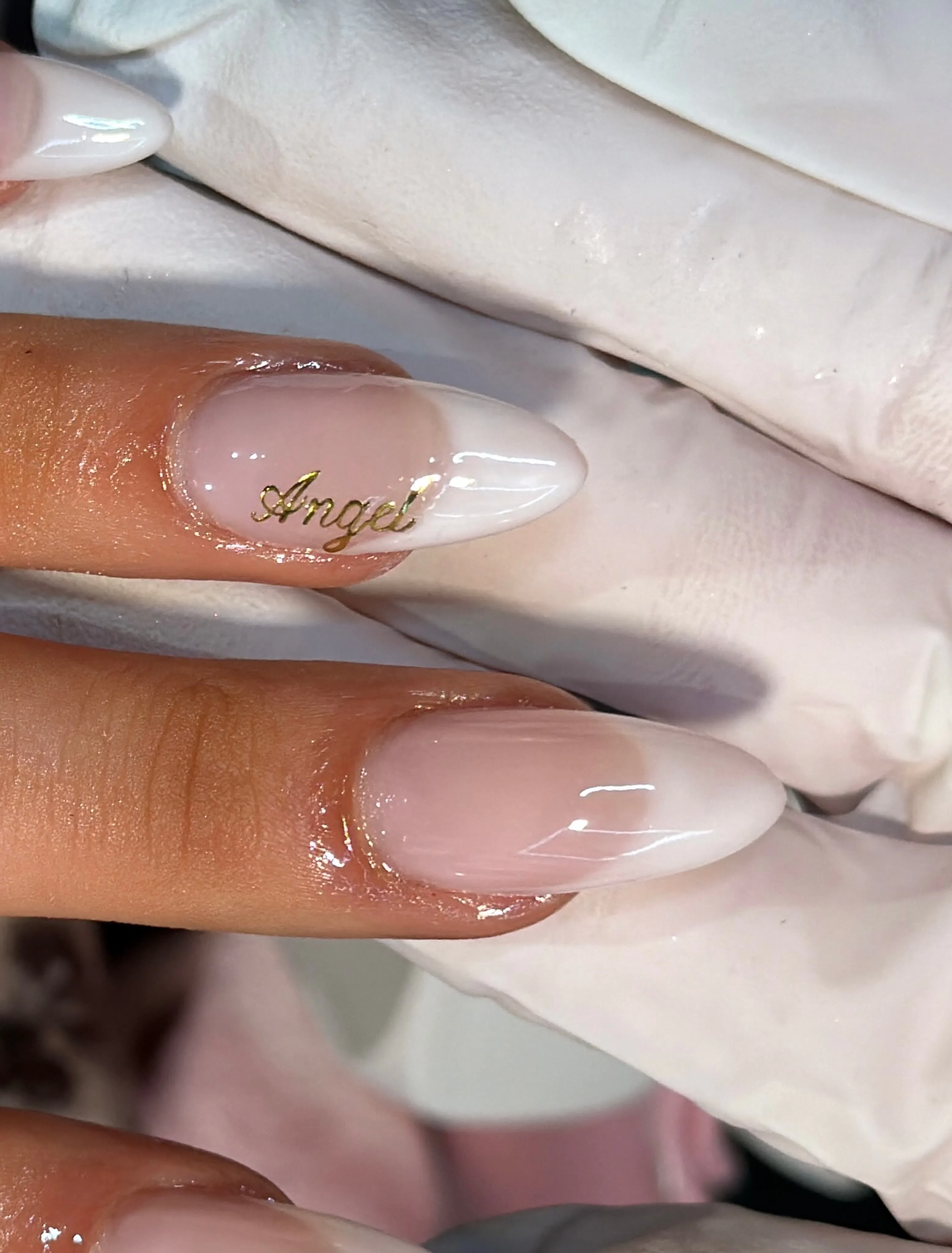 Close up of the "Angel" accent on Tate McRae's french manicure for the VS fashion show 2026