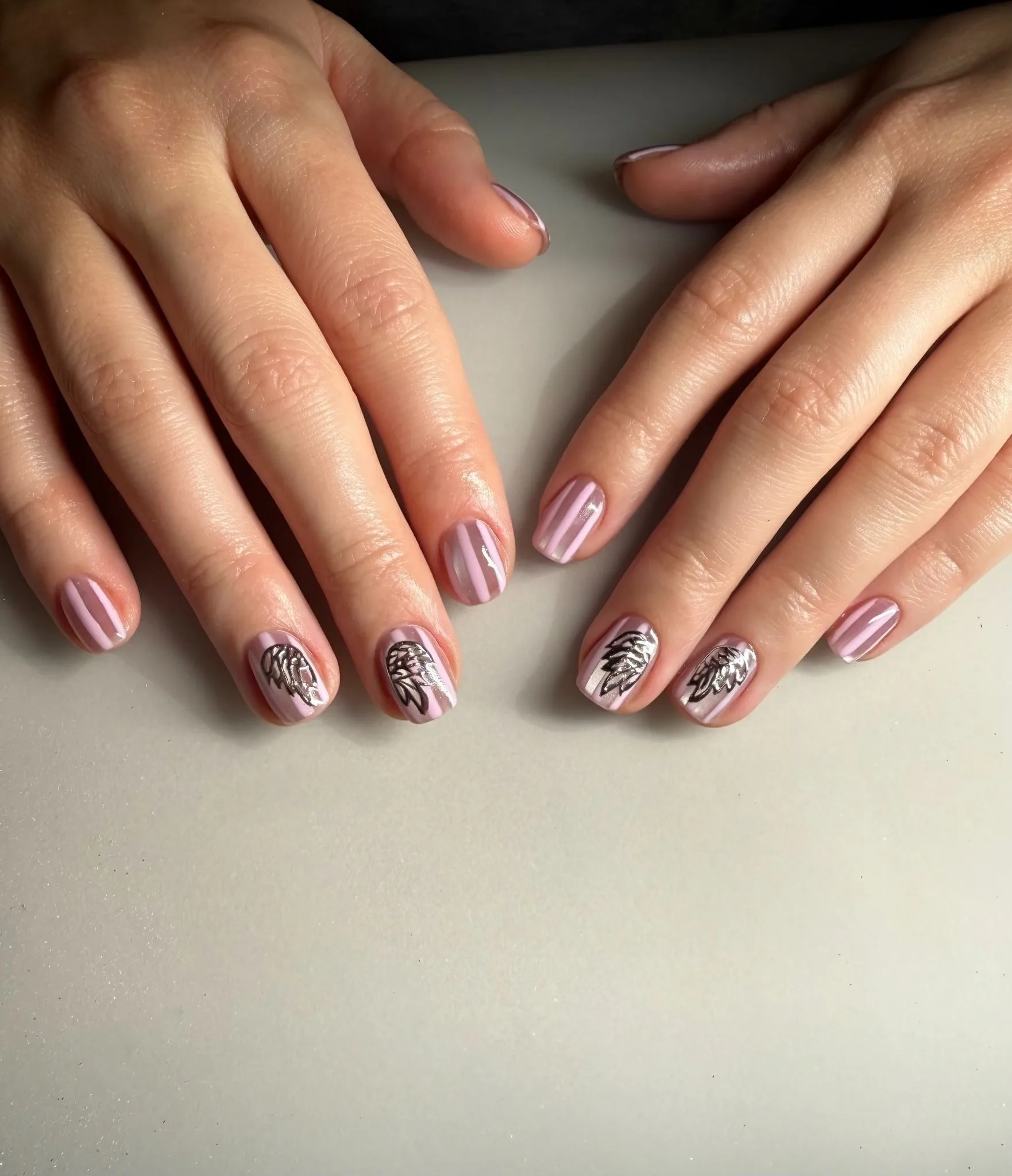 A close up of Megan Moroney's angel wing striped manicure