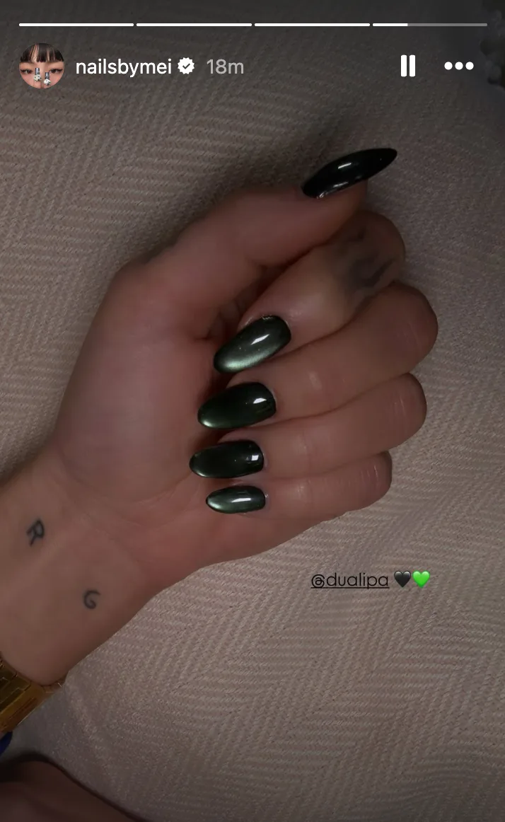 A close up of Dua Lipa's green velvet manicure