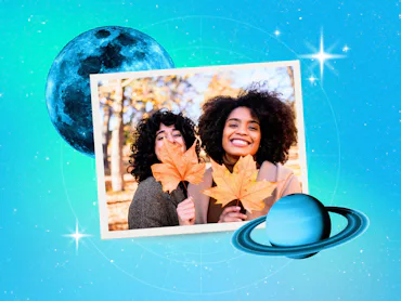 Young women playing with leaves after reading their November 2026 horoscope.