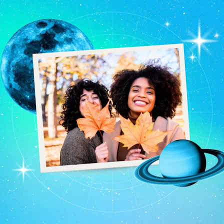 Young women playing with leaves after reading their November 2026 horoscope.