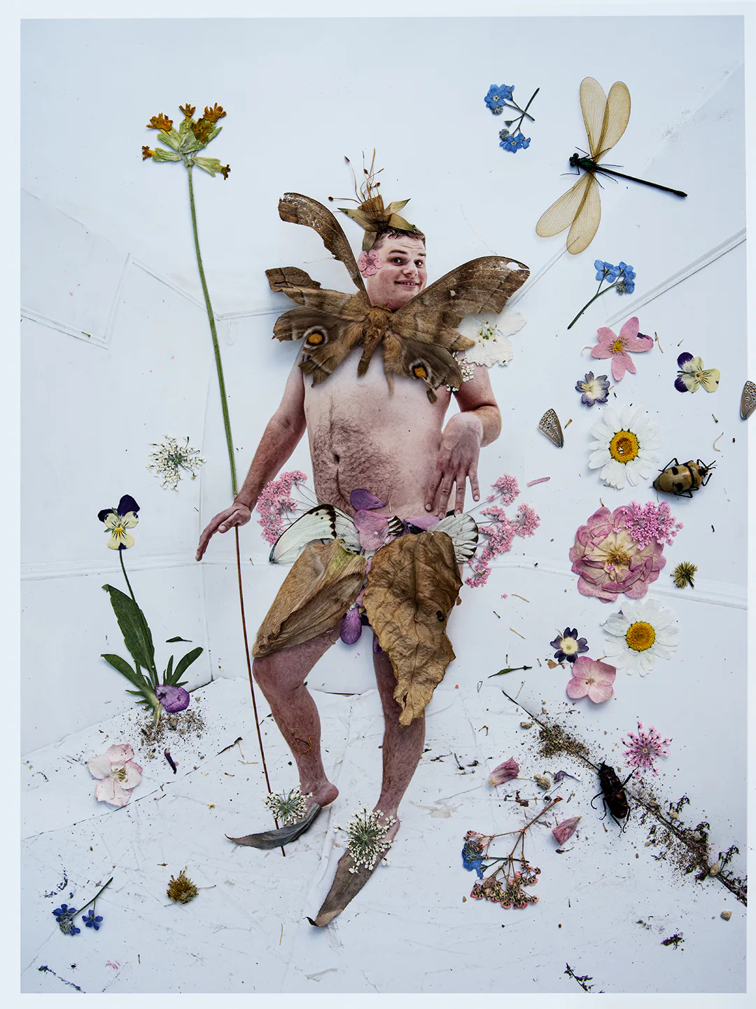 Joe Sweeney as a fairy with insects and flowers.