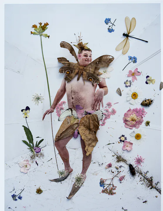 Joe Sweeney as a fairy with insects and flowers.