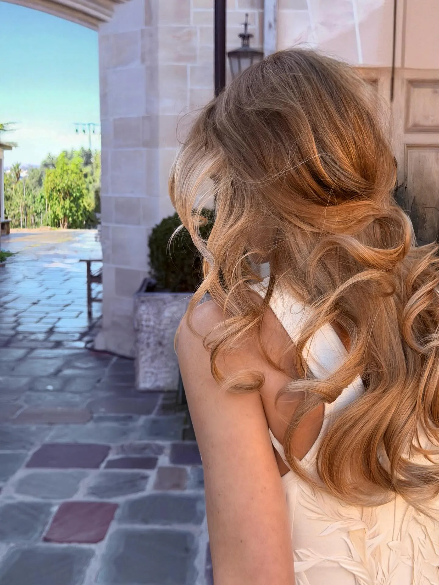 Margot Robbie's swirling curls, seen from the back