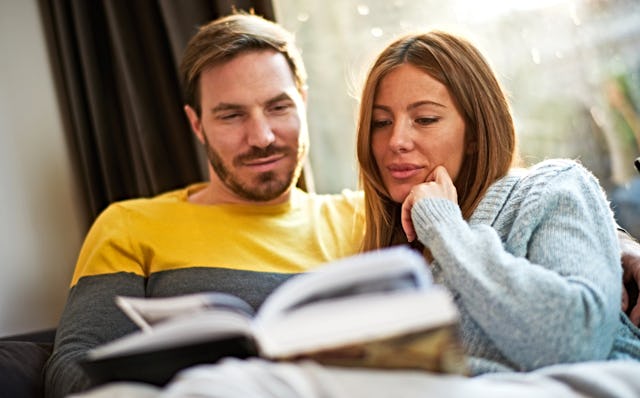 Man and woman on bed reading