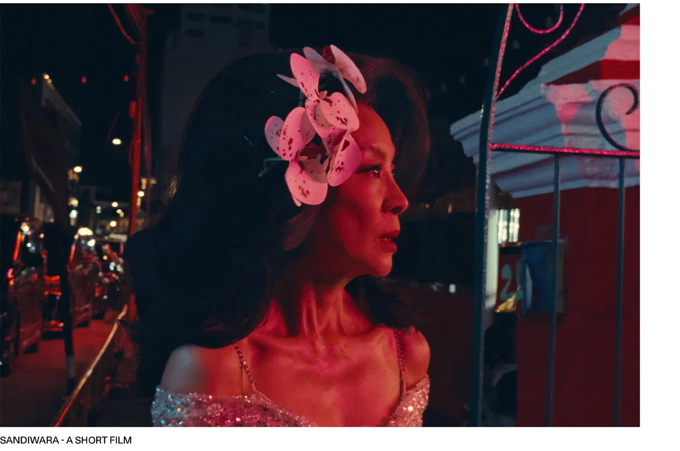 Michelle Yeoh with orchids in her teased hair