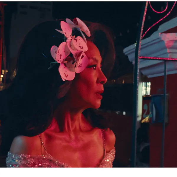 Michelle Yeoh with orchids in her teased hair