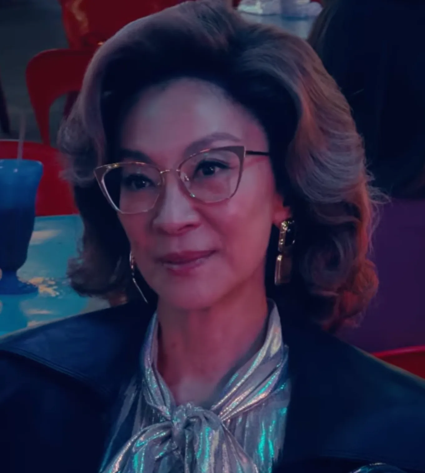 Michelle Yeoh as the food critic in a coiffed hairstyle