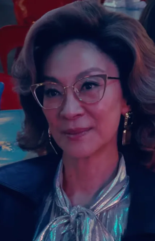 Michelle Yeoh as the food critic in a coiffed hairstyle
