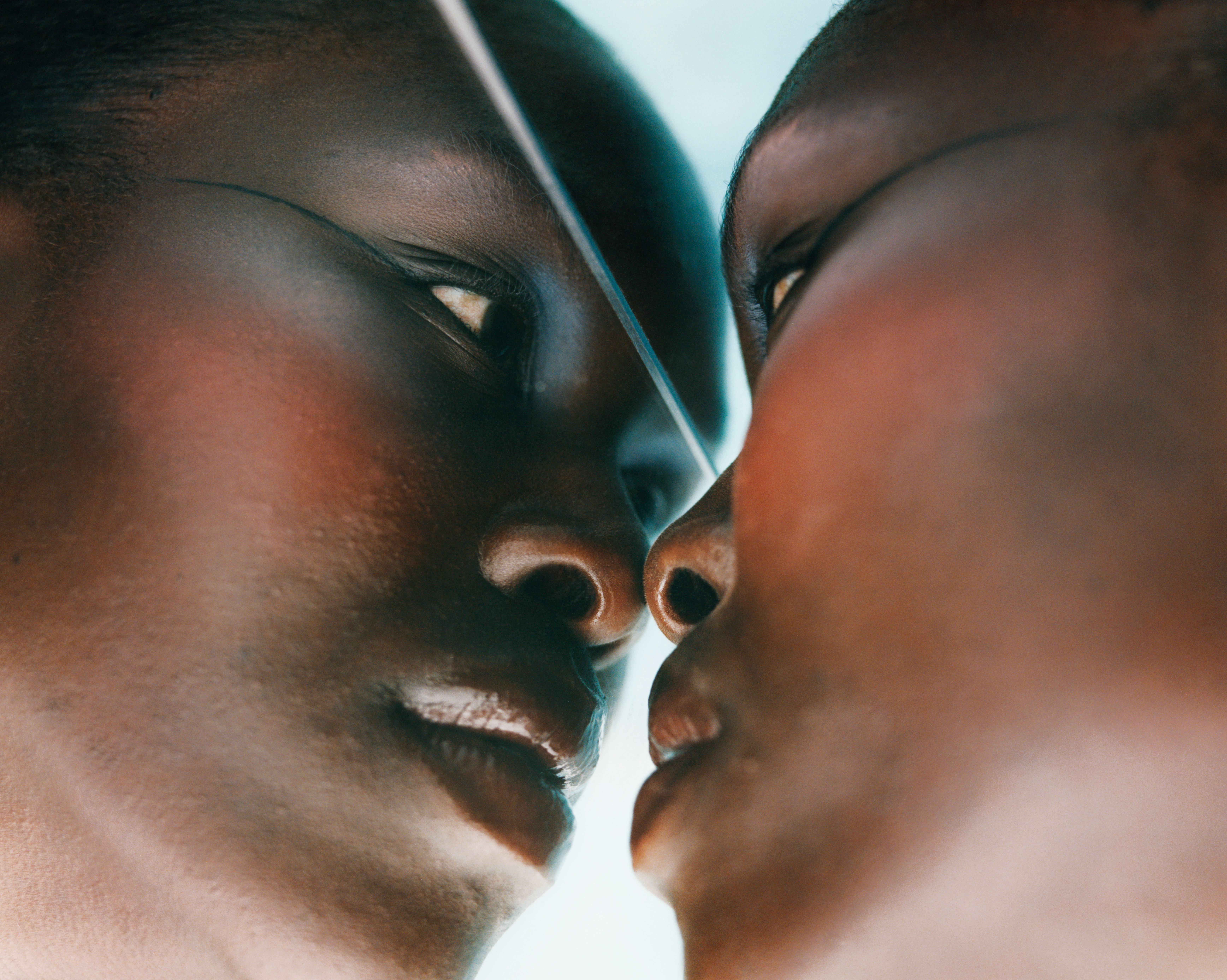 a photograph of a person looking in the mirror