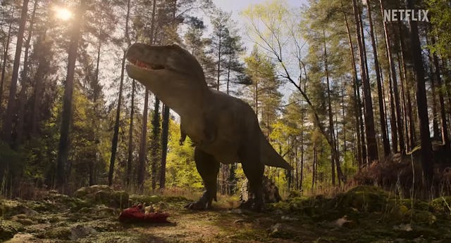 CGI T-Rex stands in a clearing in a screengrab from Netflix's The Dinosaurs, a new family-friendly m...