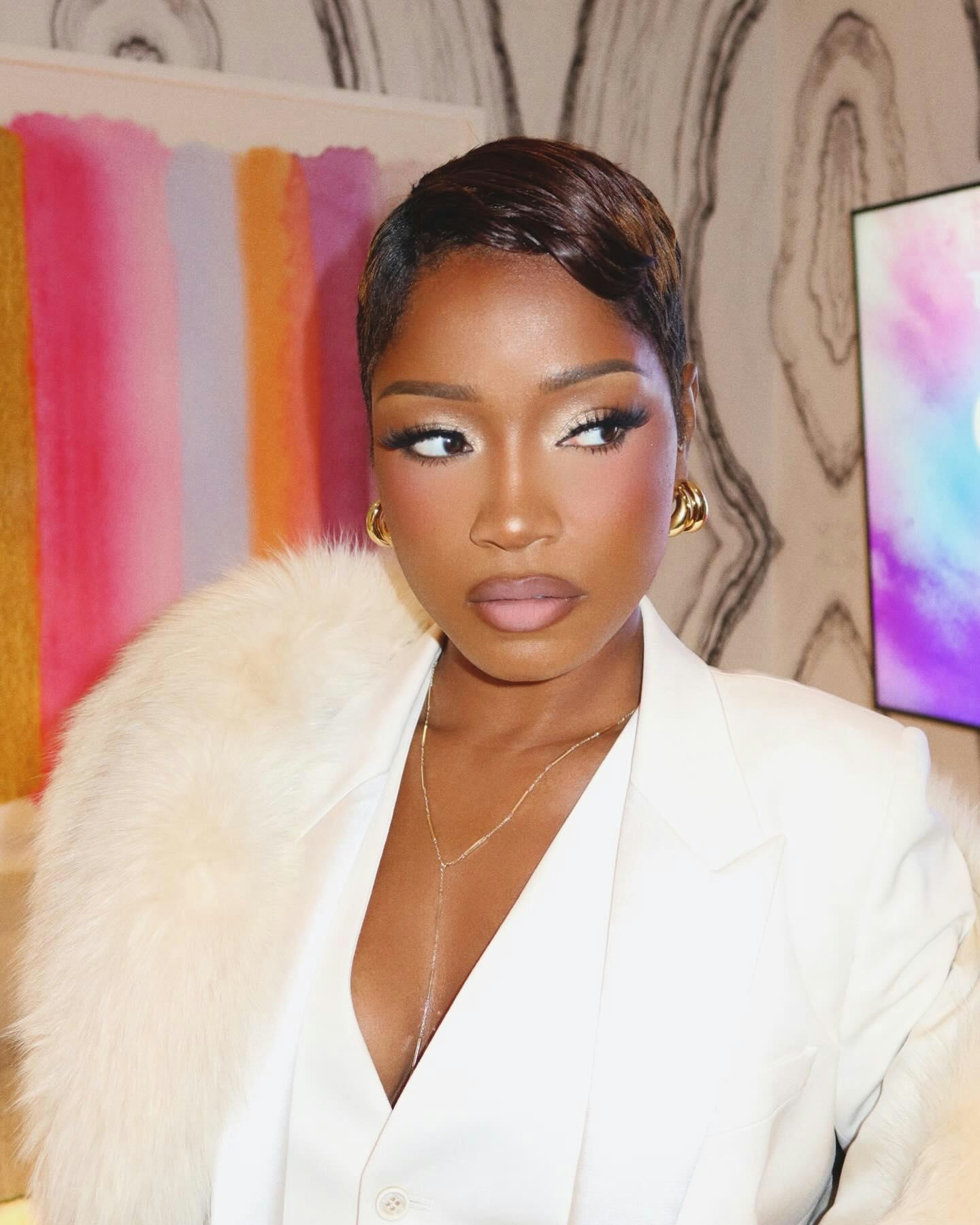 Keke Palmer with frosty eyeshadow looking away from the camera