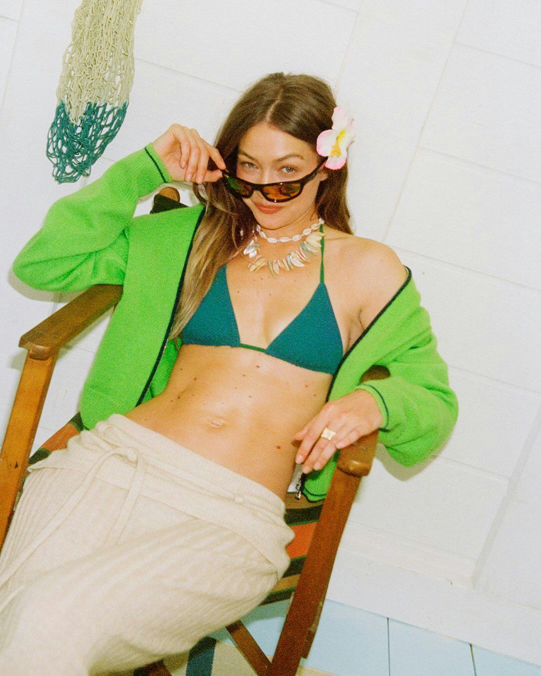 Gigi Hadid wore a bikini and puka shell necklace for a Guest In Residence campaign.