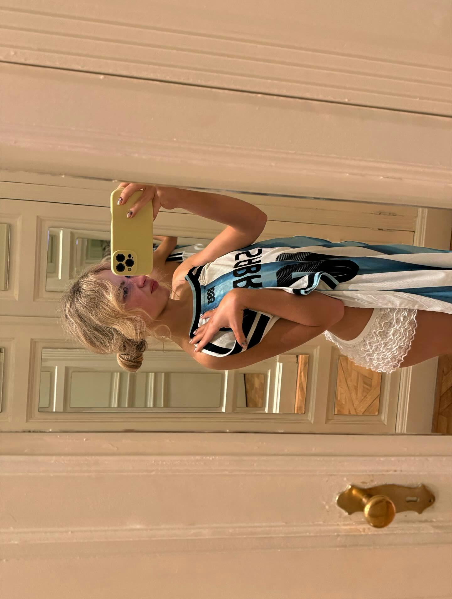 Sabrina Carpenter wears a jersey. 