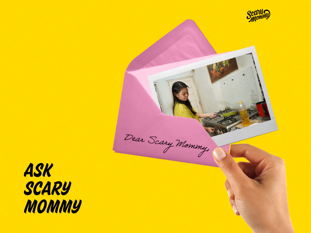 A woman holding a letter that says, "Ask Scary Mommy."