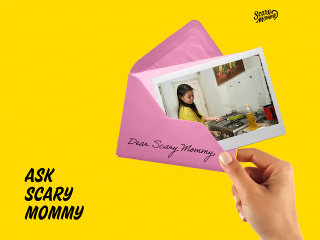 A woman holding a letter that says, "Ask Scary Mommy."