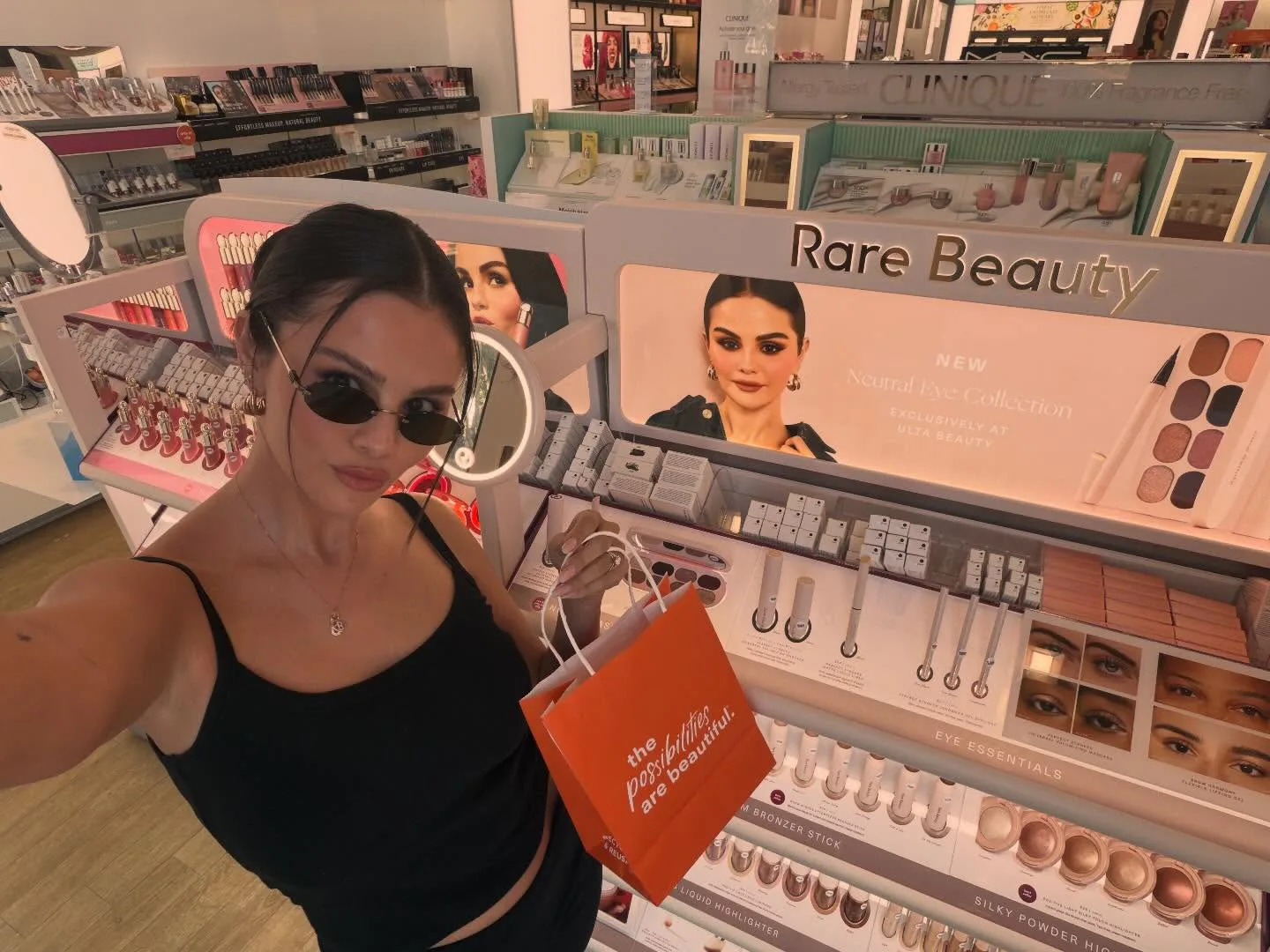 Selena Gomez wearing a center-parted bun with face-framing pieces at Ulta