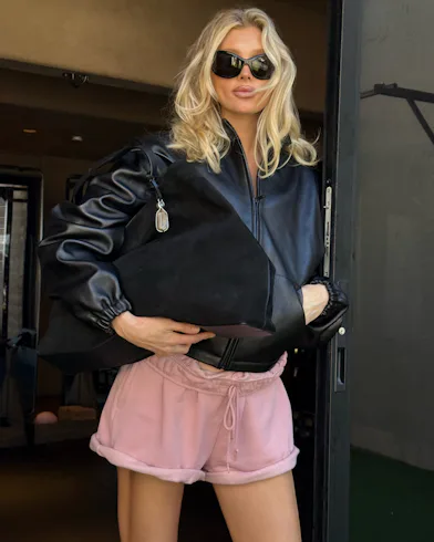 Elsa Hosk wears a leather jacket and sweat shorts to the gym.