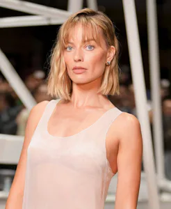 Margot Robbie at the Chanel fashion show before wearing a tweed jacket.