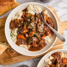 beef stew served over mashed potatoes in a story about easy st. patrick's day recipes