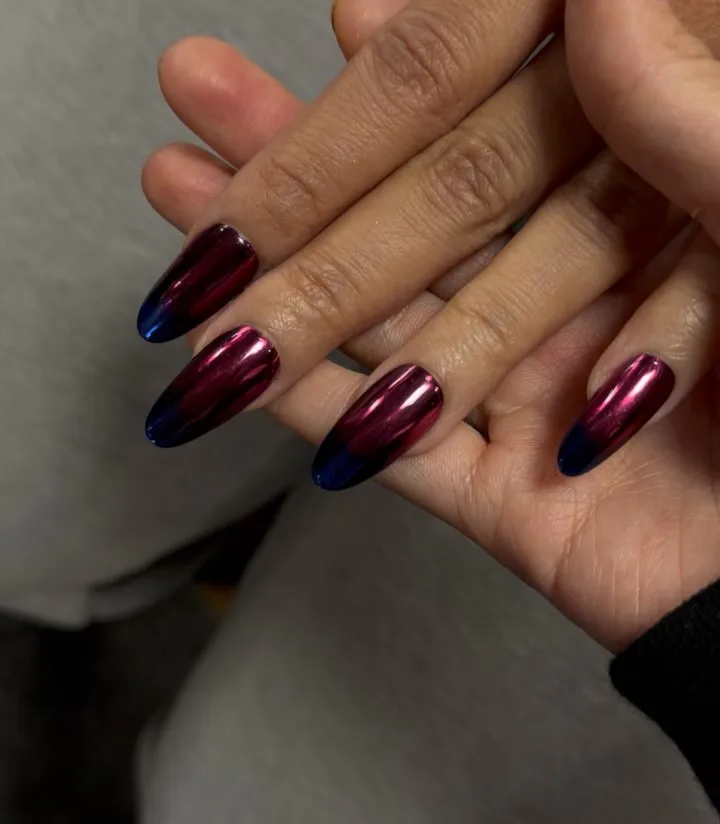 close up of Cardi B's chrome ombre manicure in magenta and blue