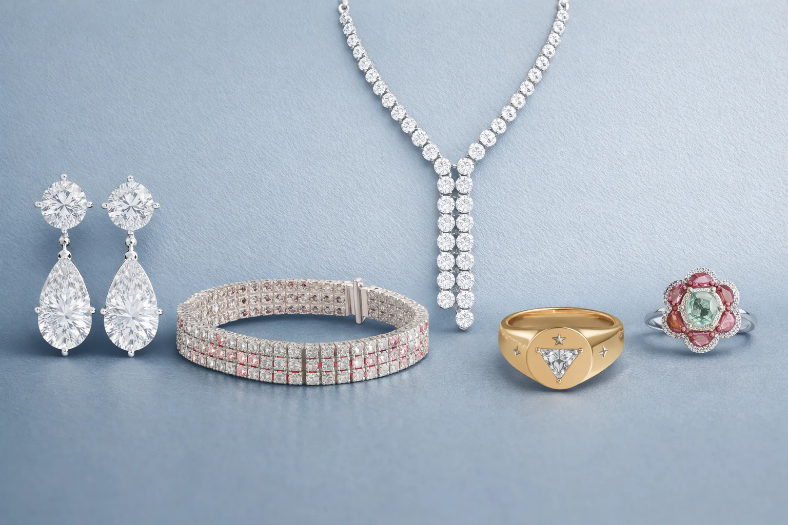 Collection of diamond jewelry including drop earrings, gold ring, floral gemstone ring, tennis brace...