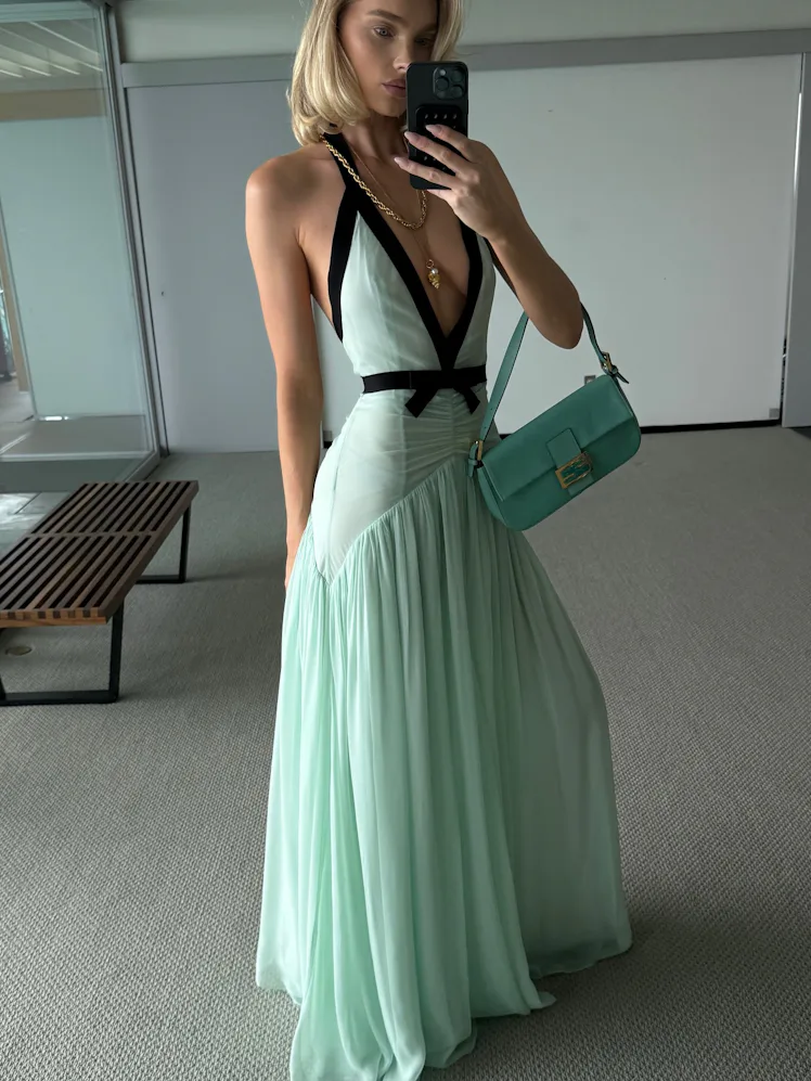 Elsa Hosk wears a seafoam dress and bag.