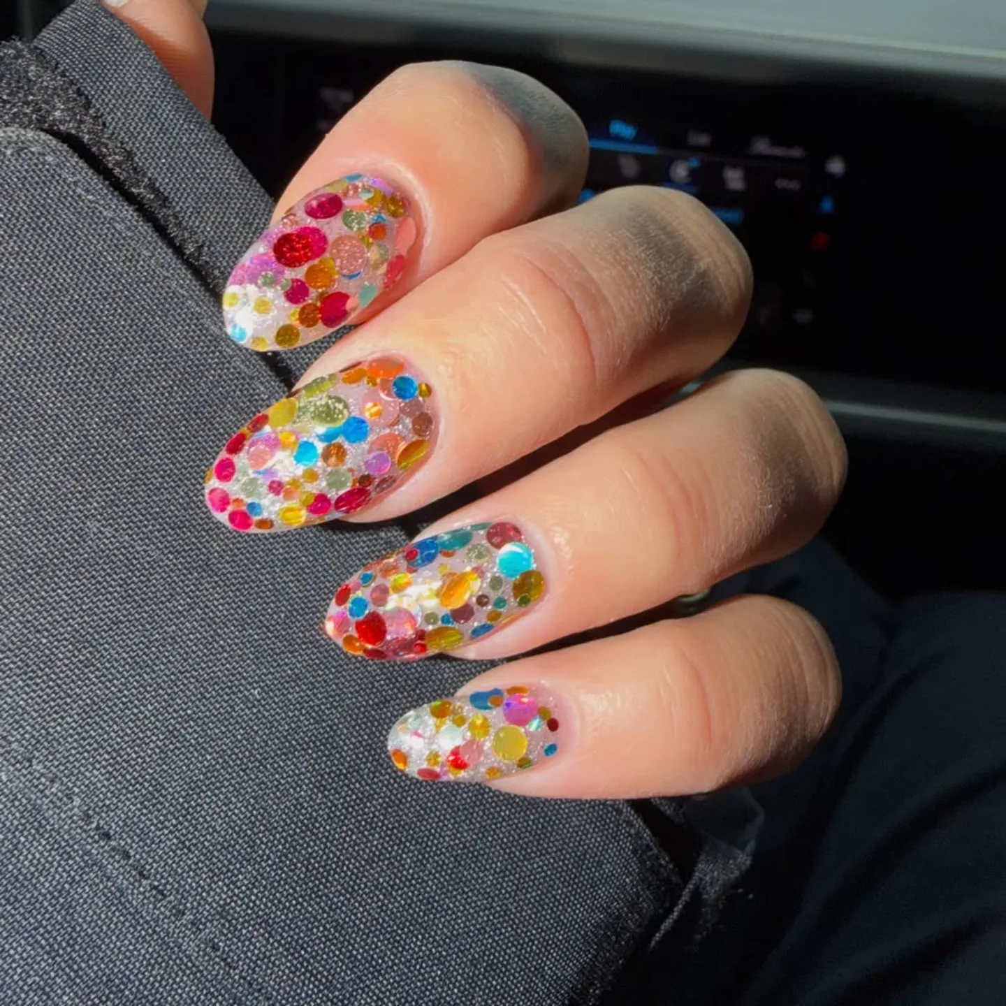 A close up of Dua Lipa's confetti manicure