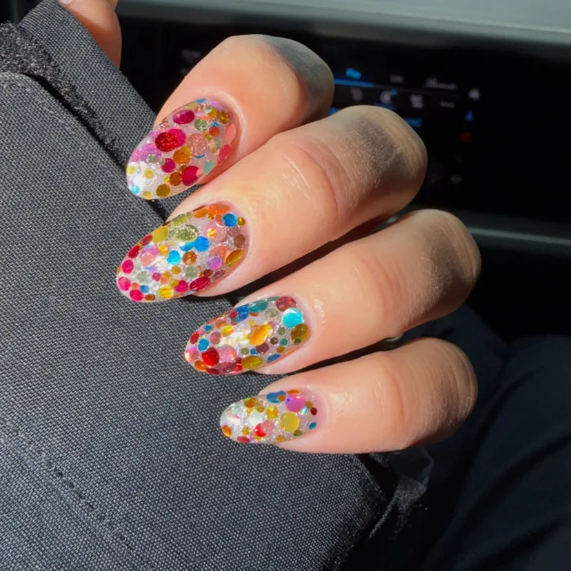 A close up of Dua Lipa's confetti manicure