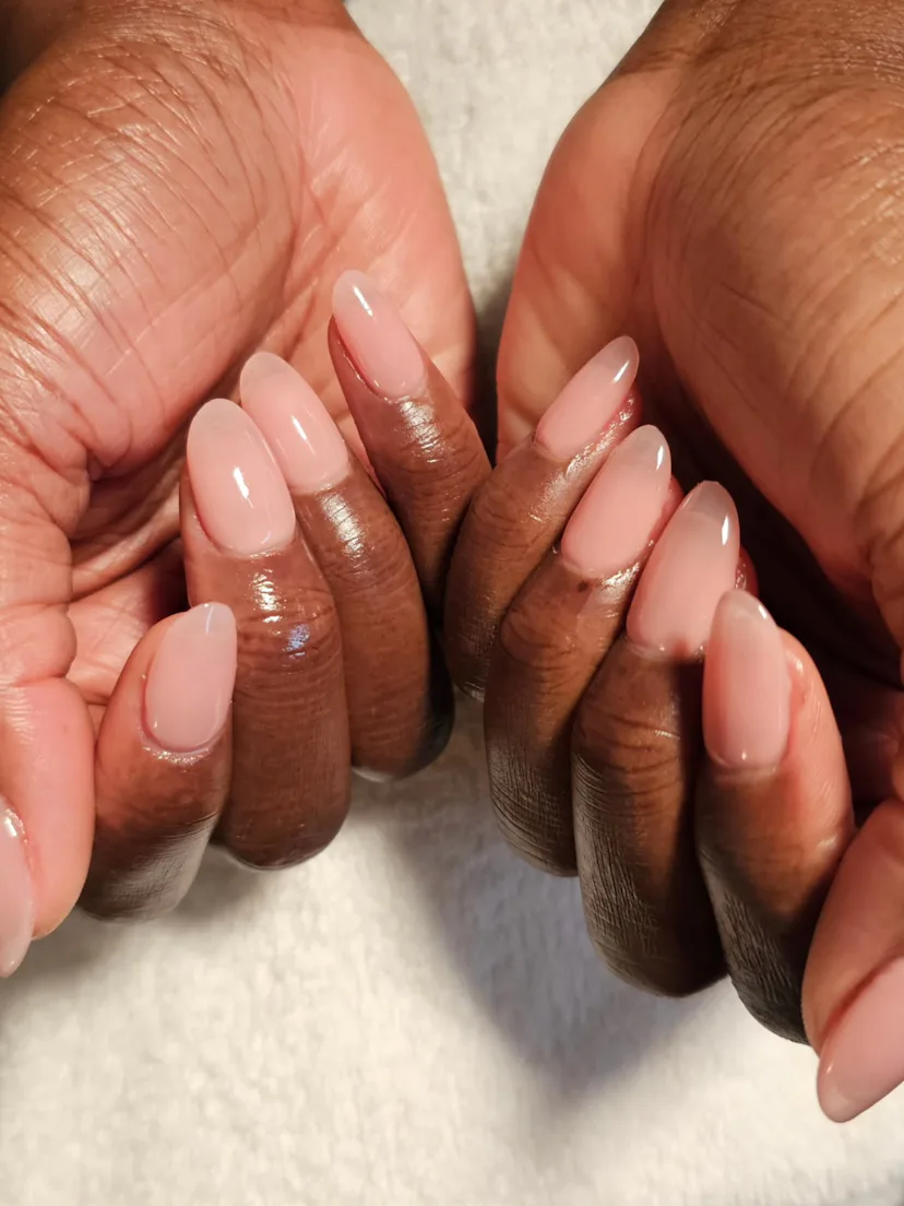 Close up of a sheer neutral manicure on Wunmi Mosaku's hands