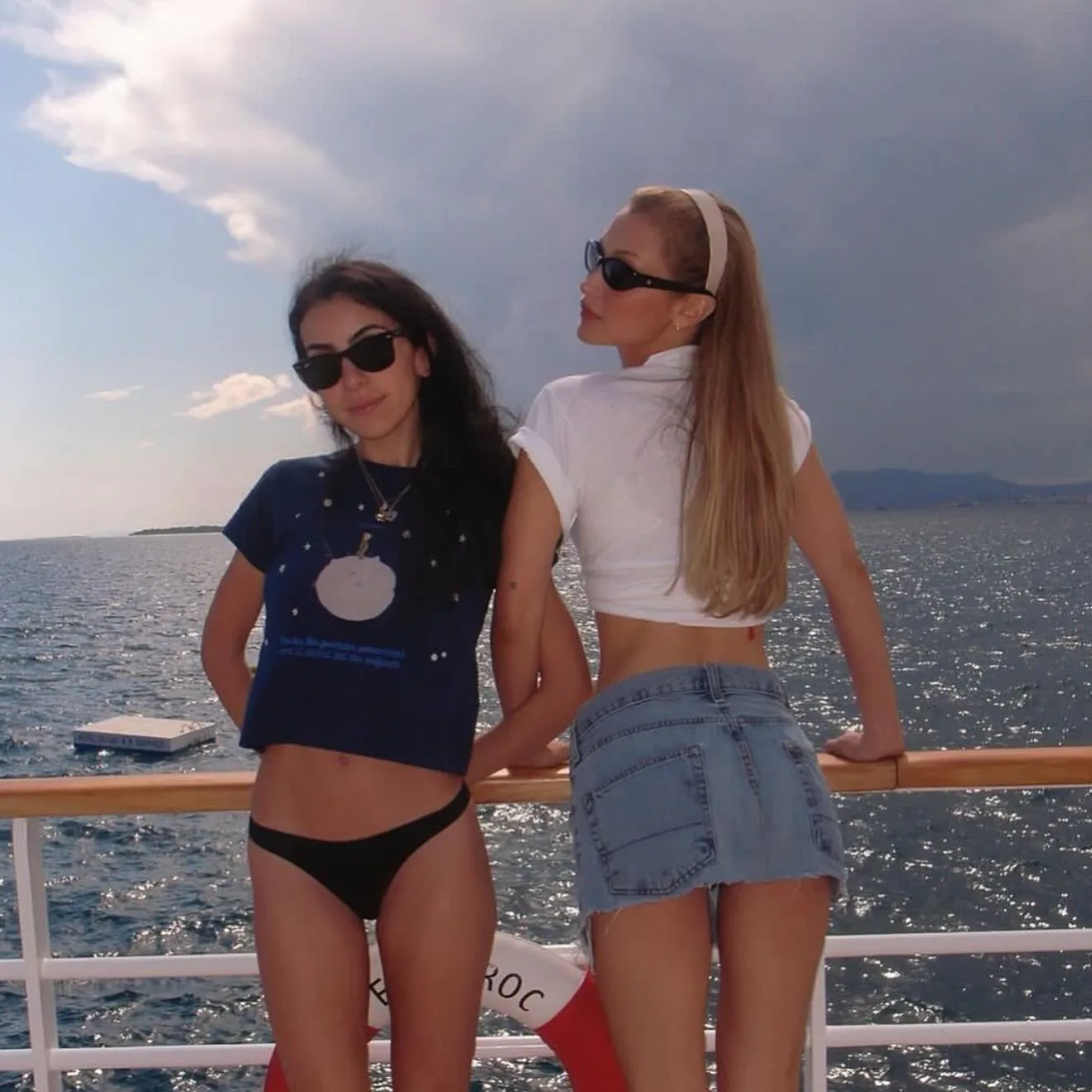 Bella Hadid wears a crop top, mini skirt, and headband. 