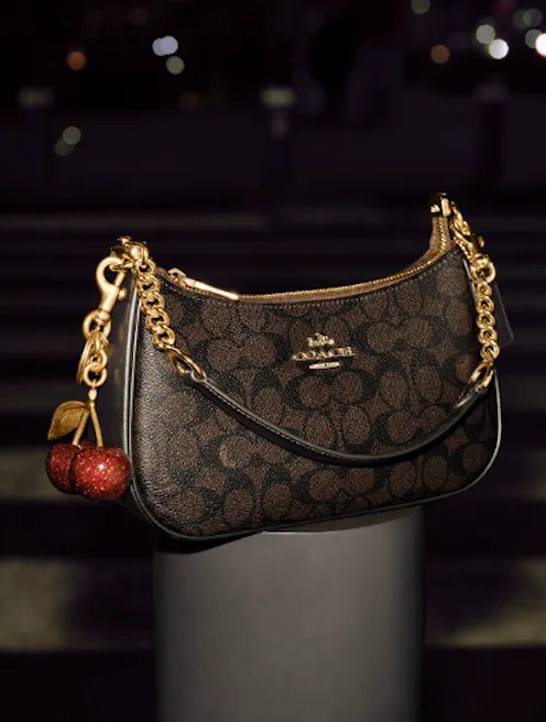 The Teri bag in a signature print, with a cherry charm.