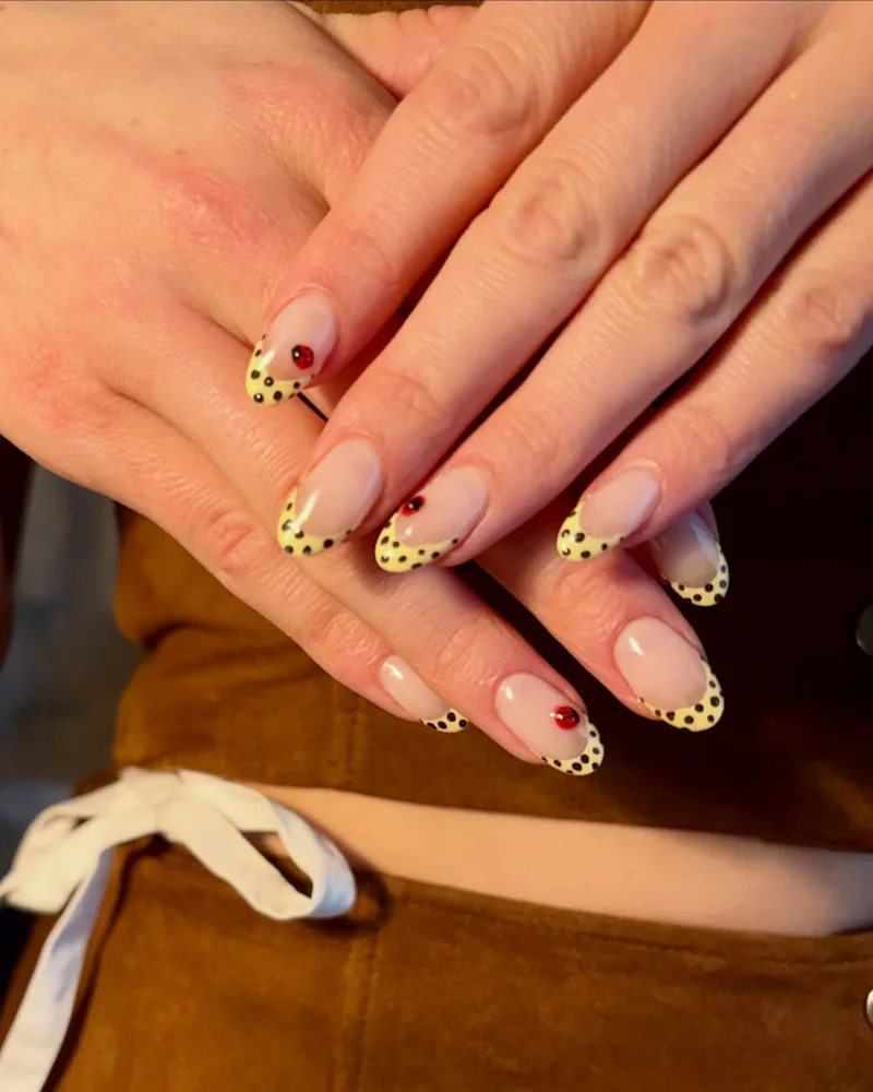 Joey King's yellow french manicure with ladybug accents