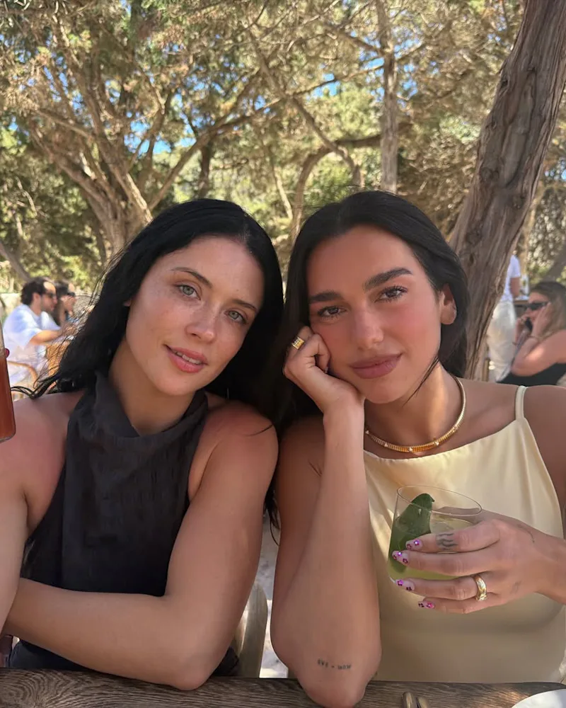 Dua Lipa with a friend, dining at a restaurant