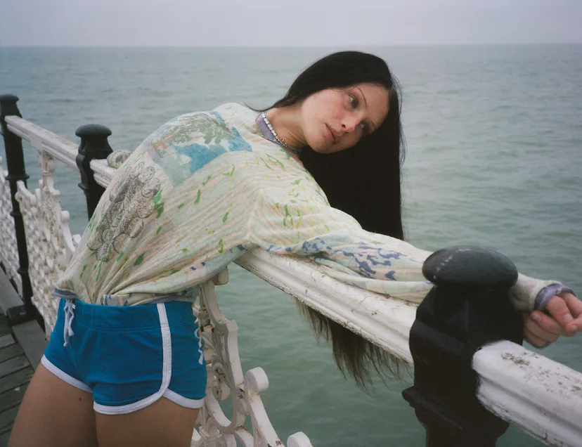 A model wearing Adrian Cashmere by the sea