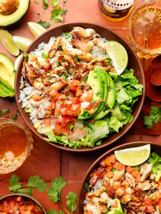 chicken carnitas in a bowl of rice with toppings, in a story about lazy dinner recipes