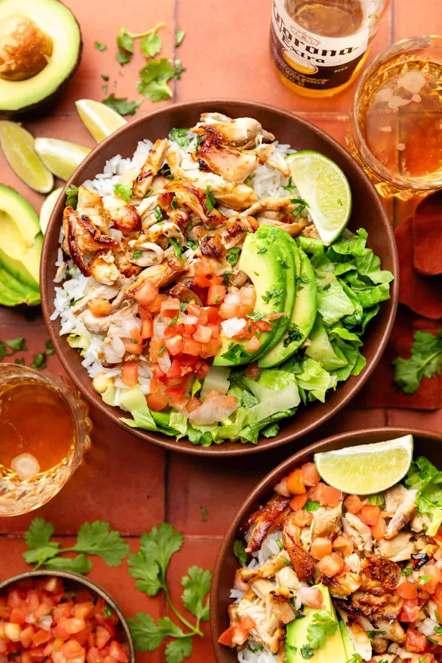 chicken carnitas in a bowl of rice with toppings, in a story about lazy dinner recipes