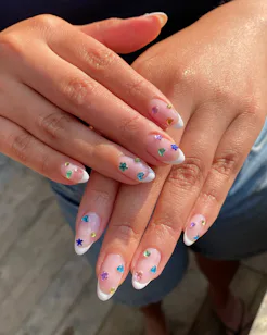 Blinged-out French tips are having a moment this summer.