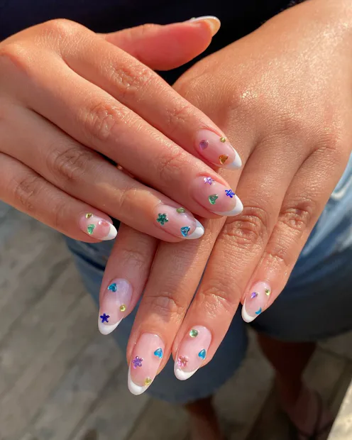 Blinged-out French tips are having a moment this summer.