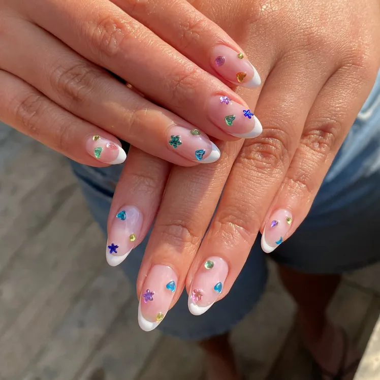 Blinged-out French tips are having a moment this summer.