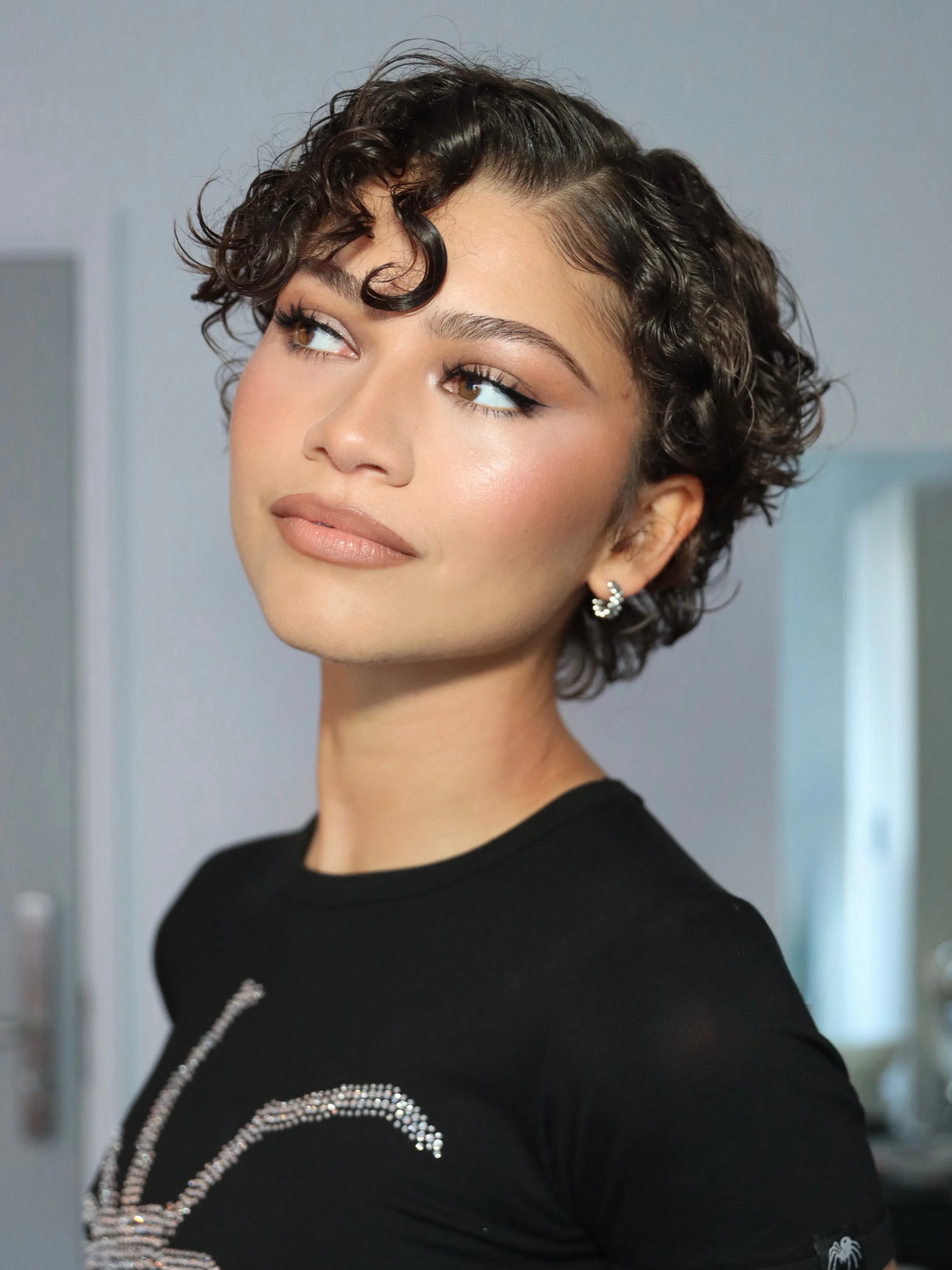 Zendaya with a springy curl cut hairstyle