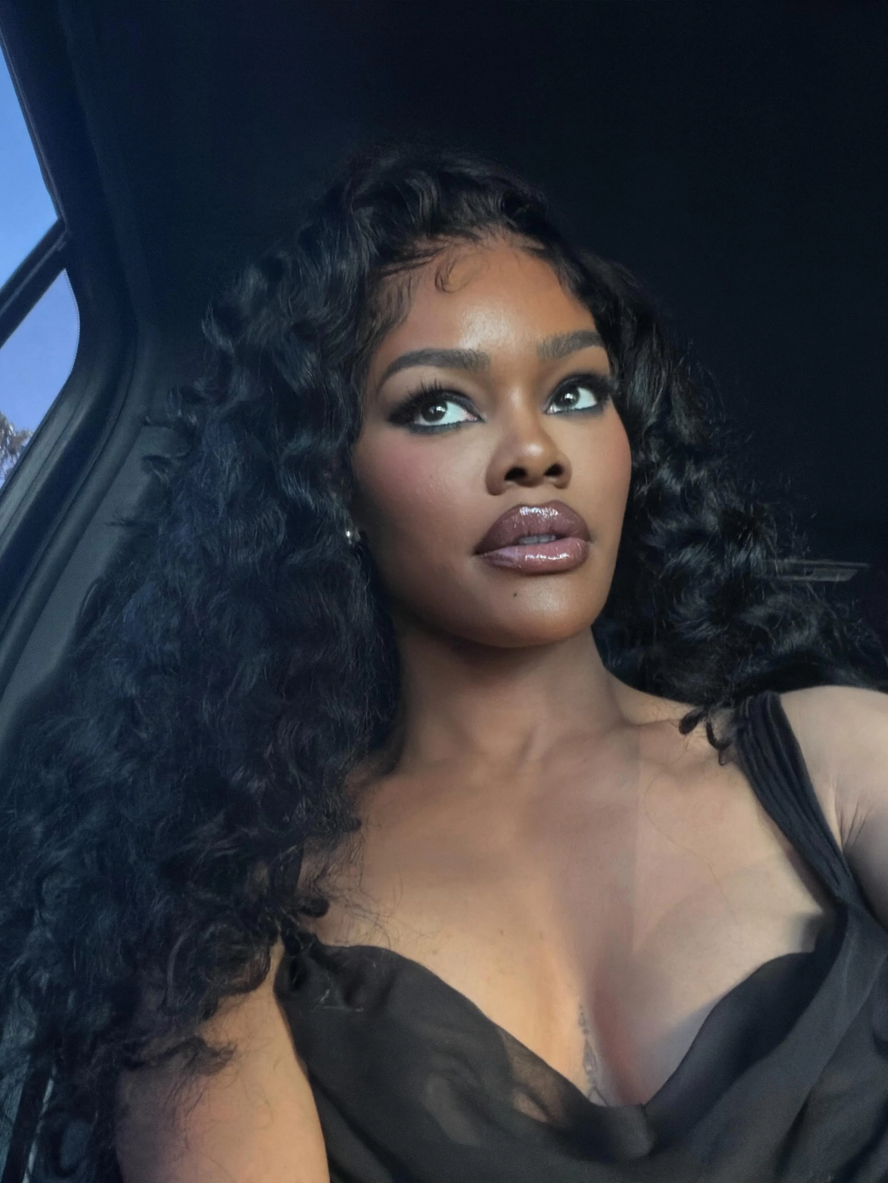 Teyana Taylor in a car, with long, flowing hair